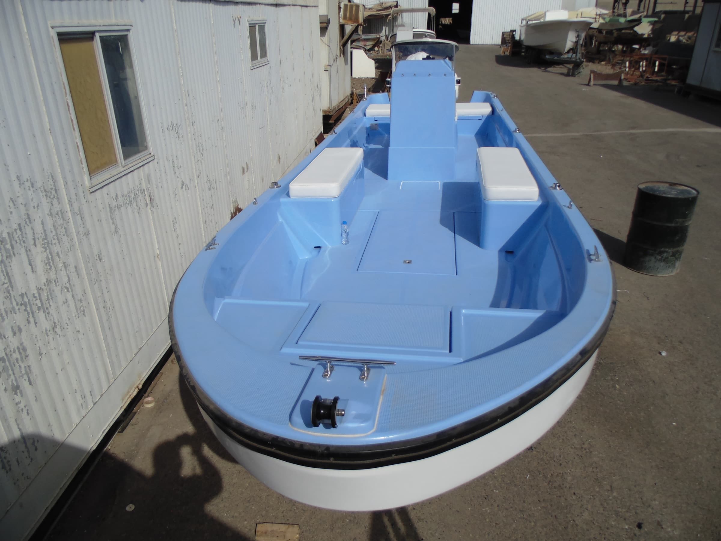 The 9.01 metre boat from the bow, pale blue interior with the console and two cushioned seats.